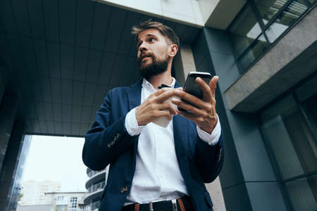 Businessman, business man with phone, businessman looking away.の写真素材