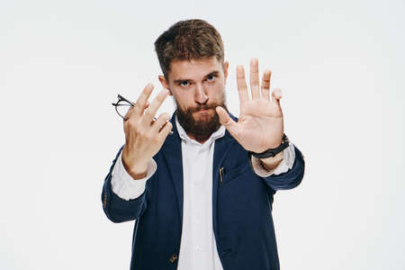 Business man showing thumbs up, businessman holding glasses, businessman on light background.の写真素材