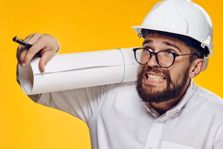Businessman in hard hat, businessman in glasses, businessman with blueprint on yellow background.