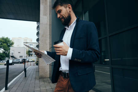 Businessman, businessman reading documents, businessman with coffee.