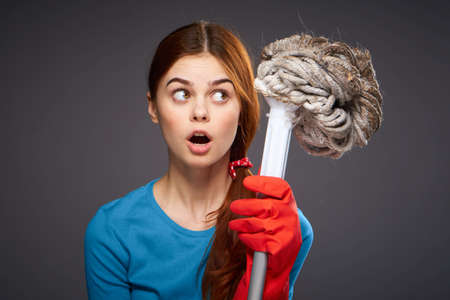 Cleaning, cleaning woman, cleanliness, woman in gloves, woman on black background.の写真素材