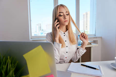 Businesswoman, office, woman working in the office, businesswoman talking on the phone.の写真素材