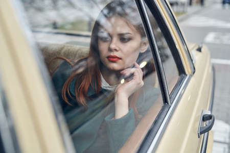 Girl in the car, woman with red hair, red lips, car, beautiful girl.