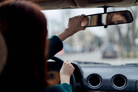 Girl in car, girl riding, road traffic, car, road, mirror in car.の写真素材
