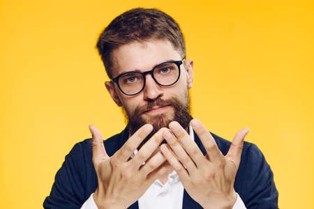 Business man with a beard, business man with glasses, man on a yellow background.の写真素材