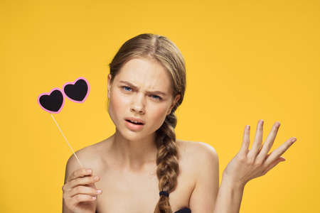 Paper accessories, party accessories, portrait, girl on a yellow background.の写真素材