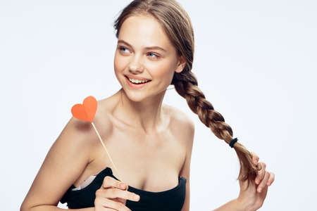 Girl on white isolated background, smile, young woman, paper accessories for parties.の写真素材