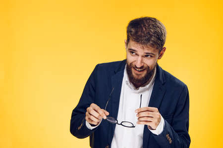 Business man surprised, business man with glasses, business man on yellow background.の写真素材