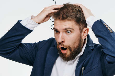 Emotion, businessman on white isolated background, business problem. Office, suit, man with a beard.の写真素材