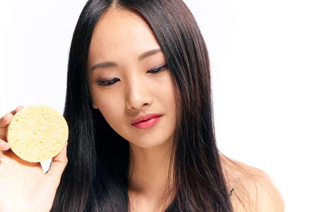 Face care woman with sponge, sponge, woman background, woman on isolated background.の写真素材