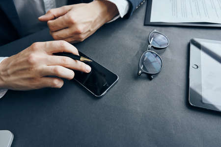 Desktop, businessman, work, office, money, phone, pen, hands.の写真素材
