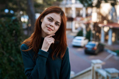 Young beautiful woman with red hair walking in winter outdoors.の写真素材