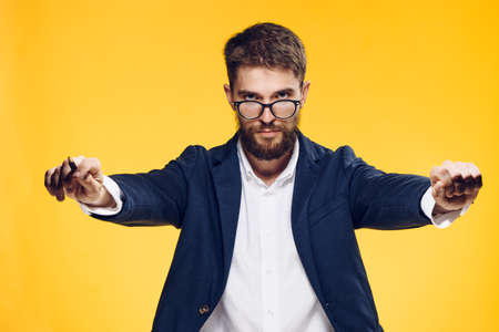 Business man with a beard on a yellow background, emotions, boss, office, work.の写真素材
