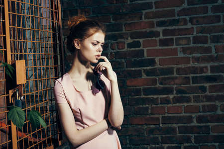Young beautiful woman in the backyard, fashion, beauty, style.の写真素材