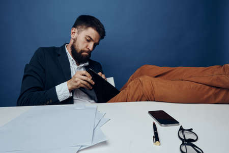 Businessman with a beard at his desk in the office.の写真素材