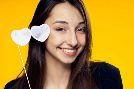 Paper accessories for parties and celebrations, woman on a yellow background.