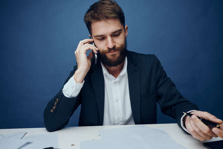 Business man with a beard at his desk in the office.の写真素材
