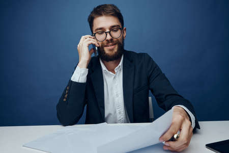 Business man with a beard at his desk in the office.の写真素材
