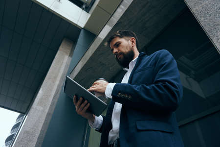 Business man with a beard on a city street.の写真素材