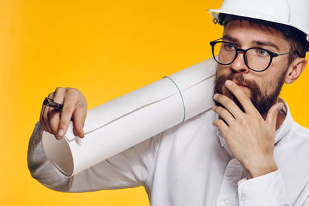 Builder in helmet, construction helmet, builder on a yellow background.の写真素材