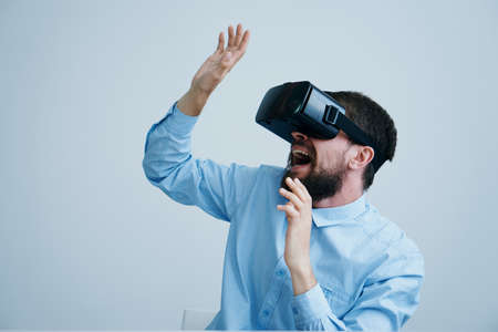 Man with a beard on a white background with glasses of virtual reality.