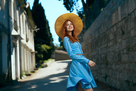 Beautiful young woman on the boulevard walking in the city.の写真素材