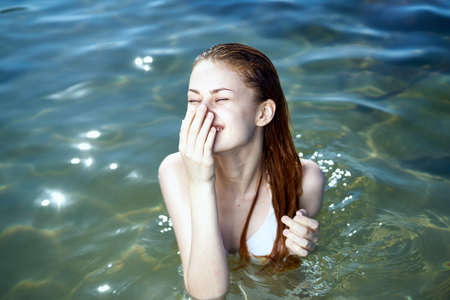 Beautiful young woman is resting on the sea, summer, ocean, beach.