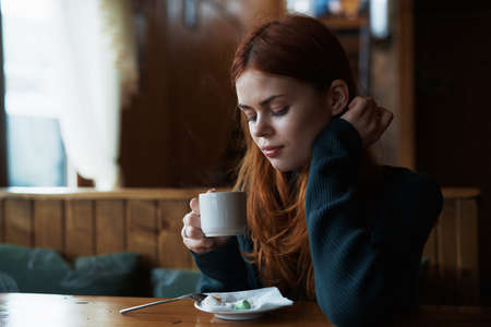 Food, breakfast, coffee, morning, young woman eating at a cafe.の写真素材