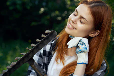 Beautiful young woman running in the garden, gardener.の写真素材