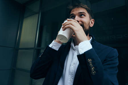 Business man with a beard on a break outdoors in the city.