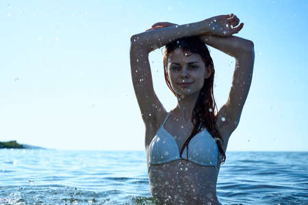 Beautiful young woman is resting on the sea, ocean, summer, sun, beach.