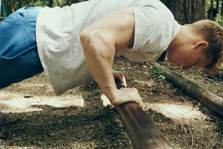 The sportsman is engaged on horizontal bars in the street.の写真素材