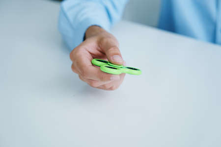 Hand on white isolated background holds a spinner.の写真素材
