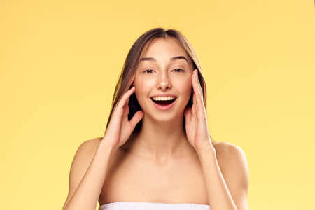 Beautiful young woman on a yellow background, portrait, emotions.