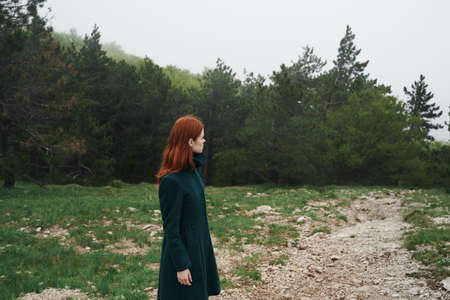Beautiful young woman walking in the mountains outdoors.の写真素材