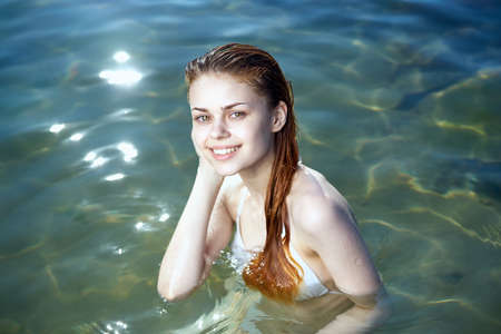 Beautiful young woman resting on the sea, ocean, beach, summer, sun.の写真素材