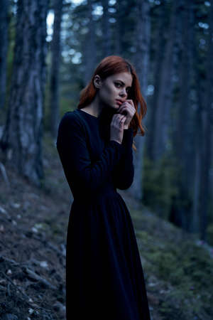 Beautiful young woman in a long dress in the forest.の写真素材