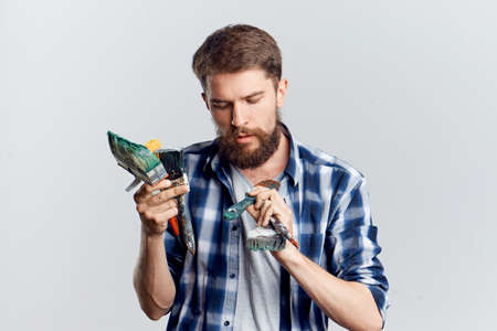 Young guy on white isolated background, repair, tools.