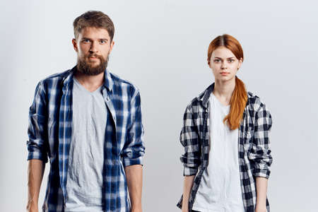 Young guy with beard and beautiful woman on white isolated background, repair, housework.の写真素材