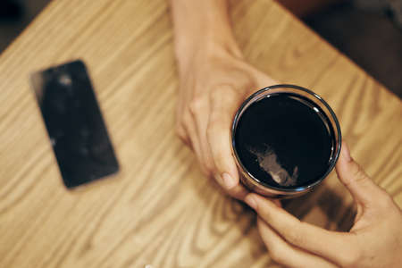 Cola, cafe, table, phone, rest, whiskey, beer, alcohol.の写真素材