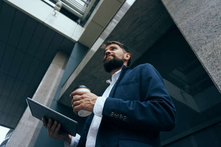 Business man with a beard on a break outdoors in the city.