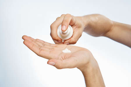 Hands, on white isolated background, cosmetic cream.の写真素材