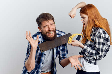 Young guy with beard and beautiful woman on white isolated background, repair, housework.の写真素材
