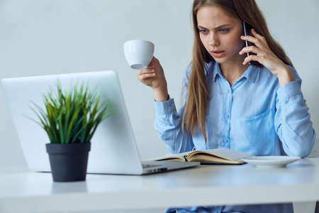 Beautiful young woman working at the computer in the office.の写真素材