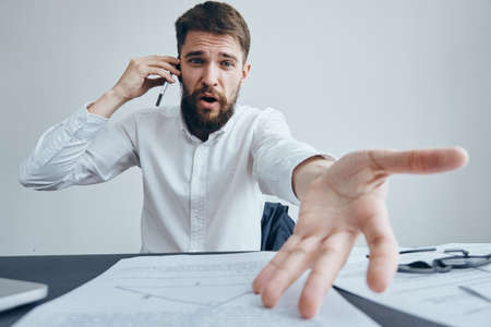 Business man with a beard working at his desk in the office.の写真素材