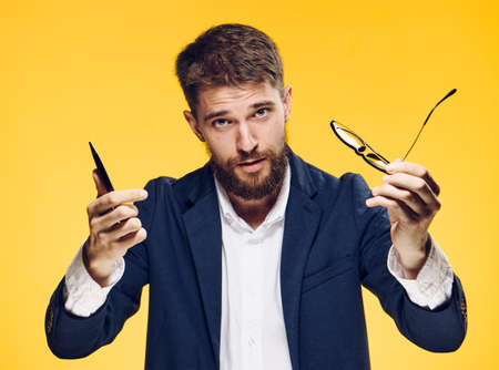 Business man with a beard on a yellow background.
