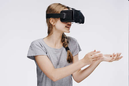 Beautiful young woman on white isolated background in virtual reality glasses.の写真素材
