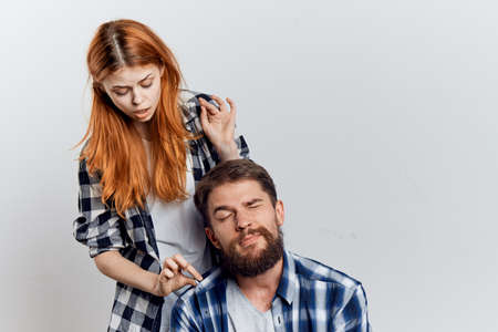 Young beautiful woman and guy with a beard on white isolated background, repair, construction tools.の写真素材