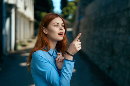 Young beautiful woman is walking outdoors in the city.の写真素材