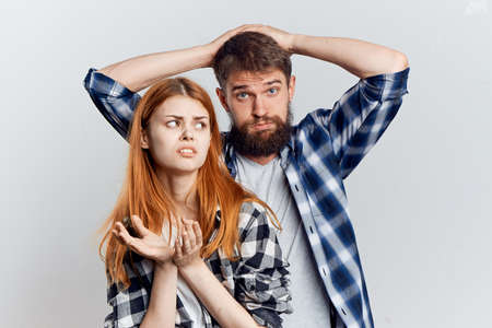 Young beautiful woman with a guy with a beard on white isolated background, repair, construction tools.の写真素材